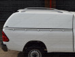Carryboy white commerical truck top with roof bars for the Toyota Hilux