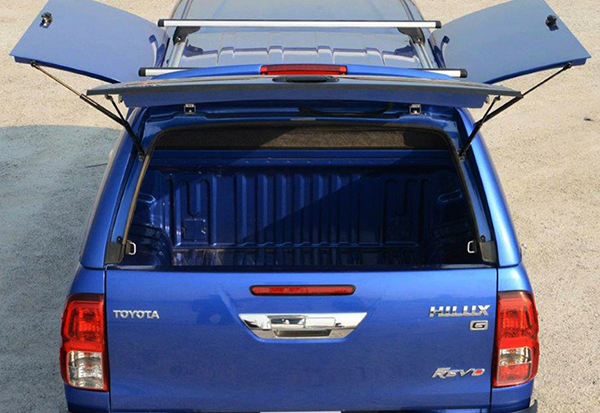 Alpha CMX gullwing truck top canopy with open side doors and tailgate on a Toyota Hilux