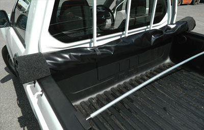 Rolled up soft tonneau cover showing support bars