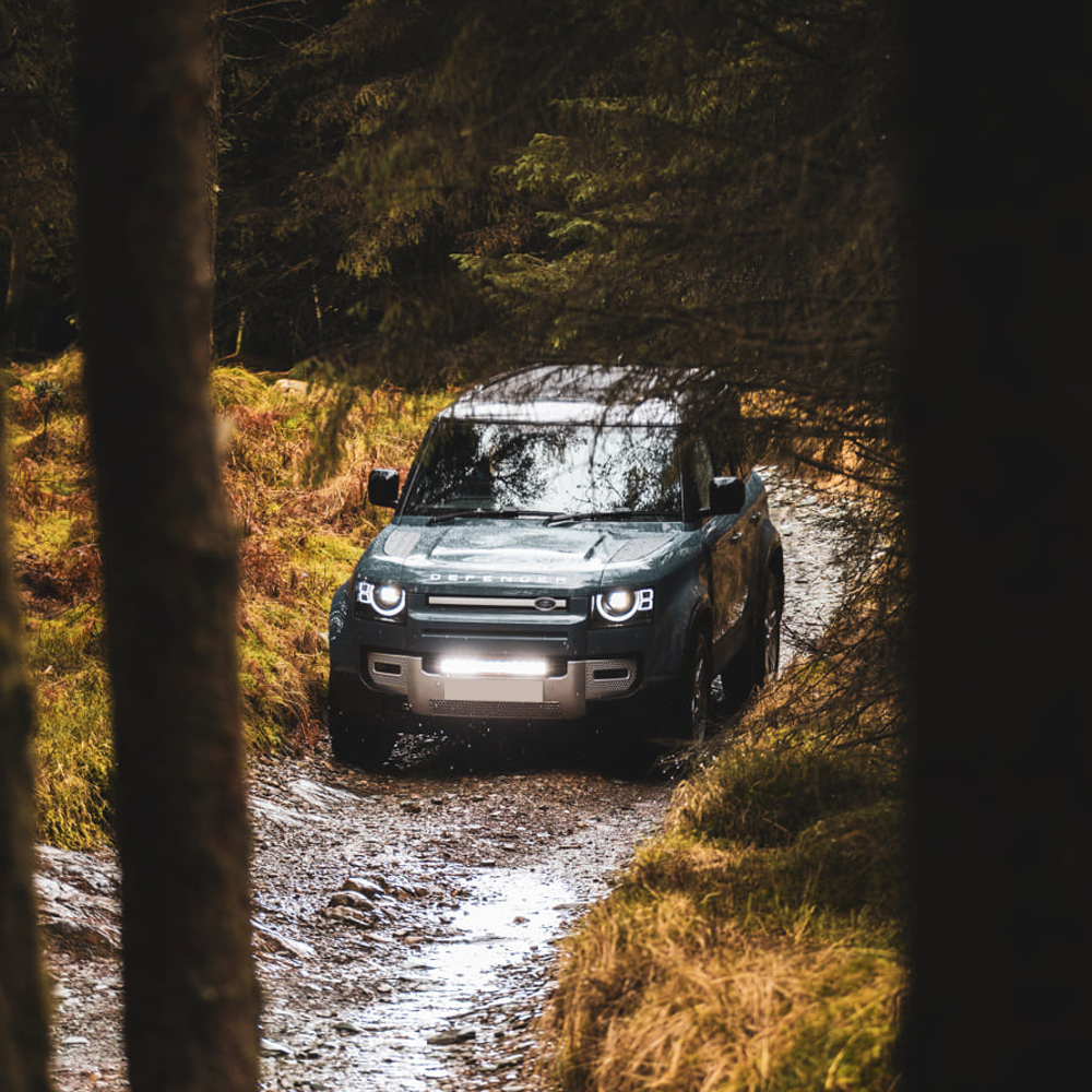 Land Rover Defender off-roading with Lazer Lamps light bar